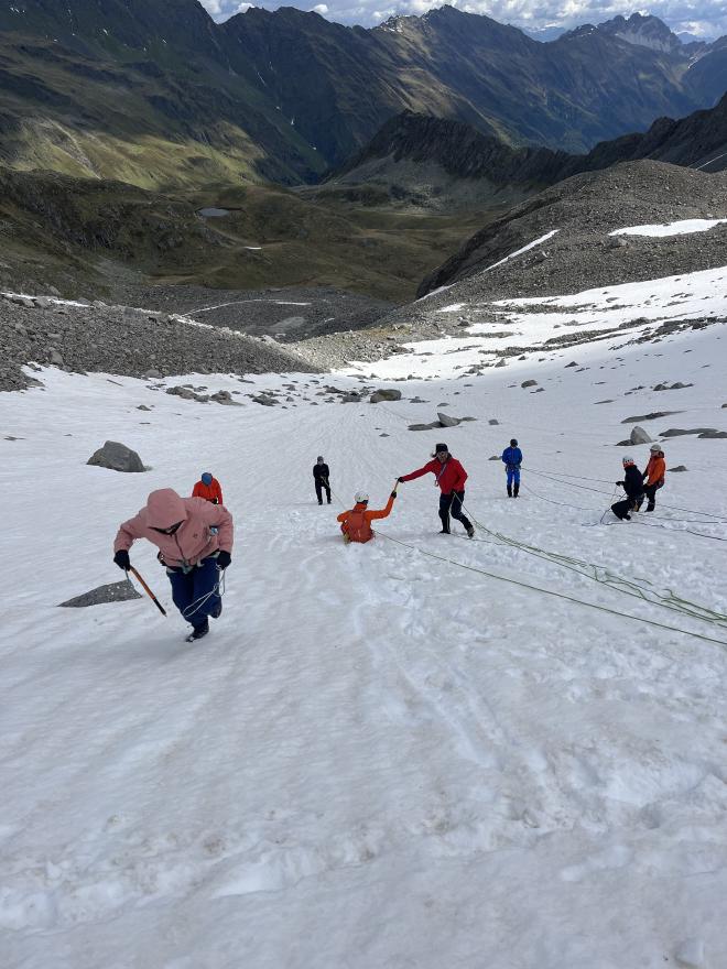 team roped up snow slope