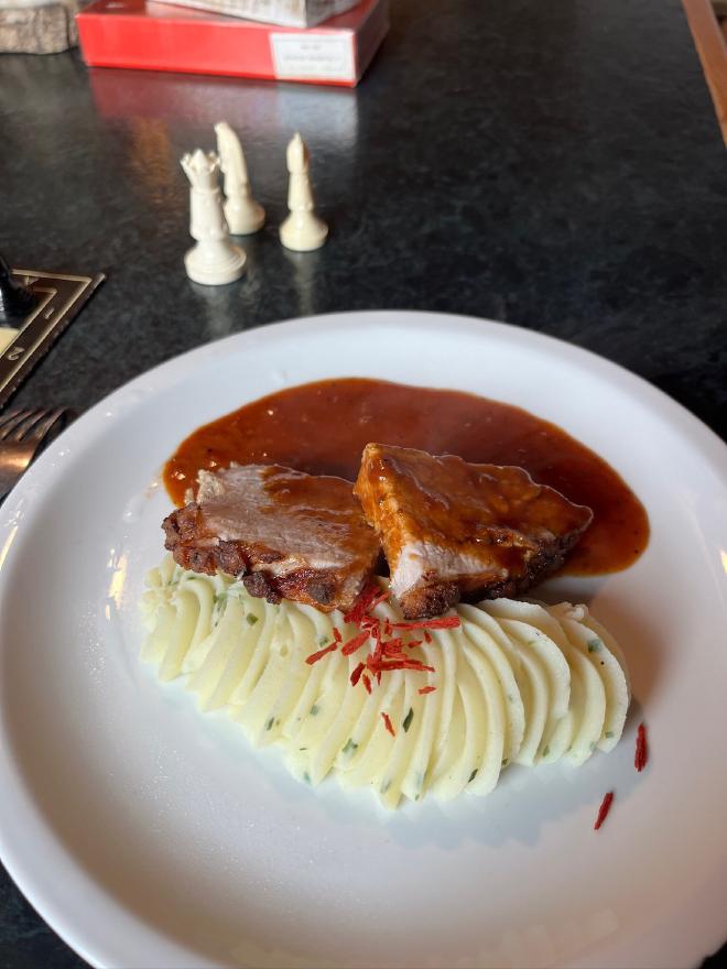Roast pork with piped mashed potato at the hut