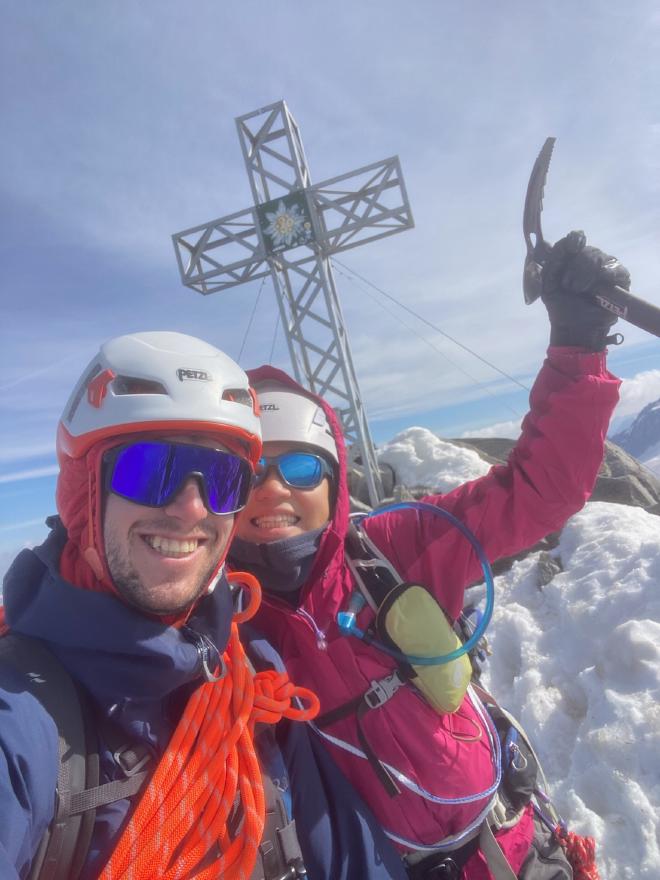 Summit selfie at the cross, ice axe raised