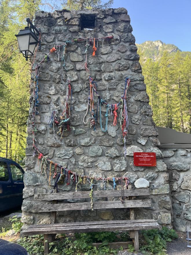 Stone tower covered in retired climbing ropes at Ailefroide