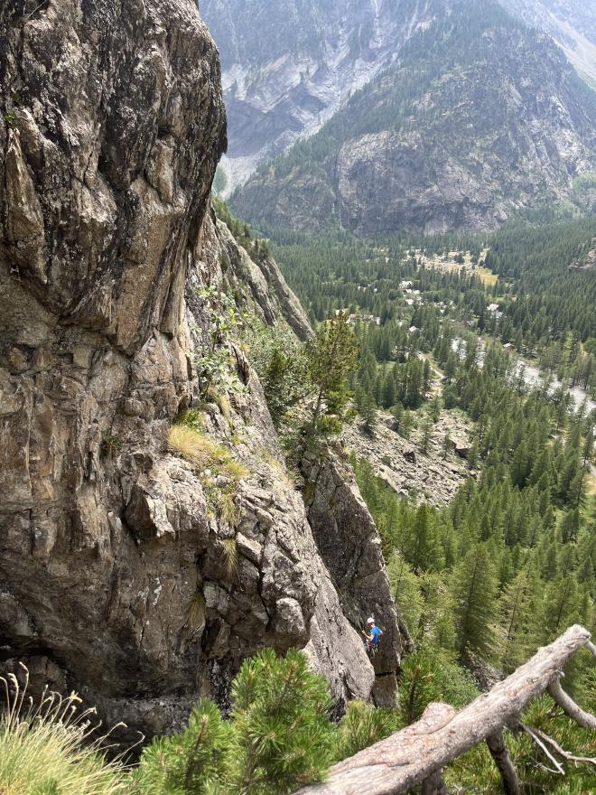Climber on a long granite multi-pitch above the valley