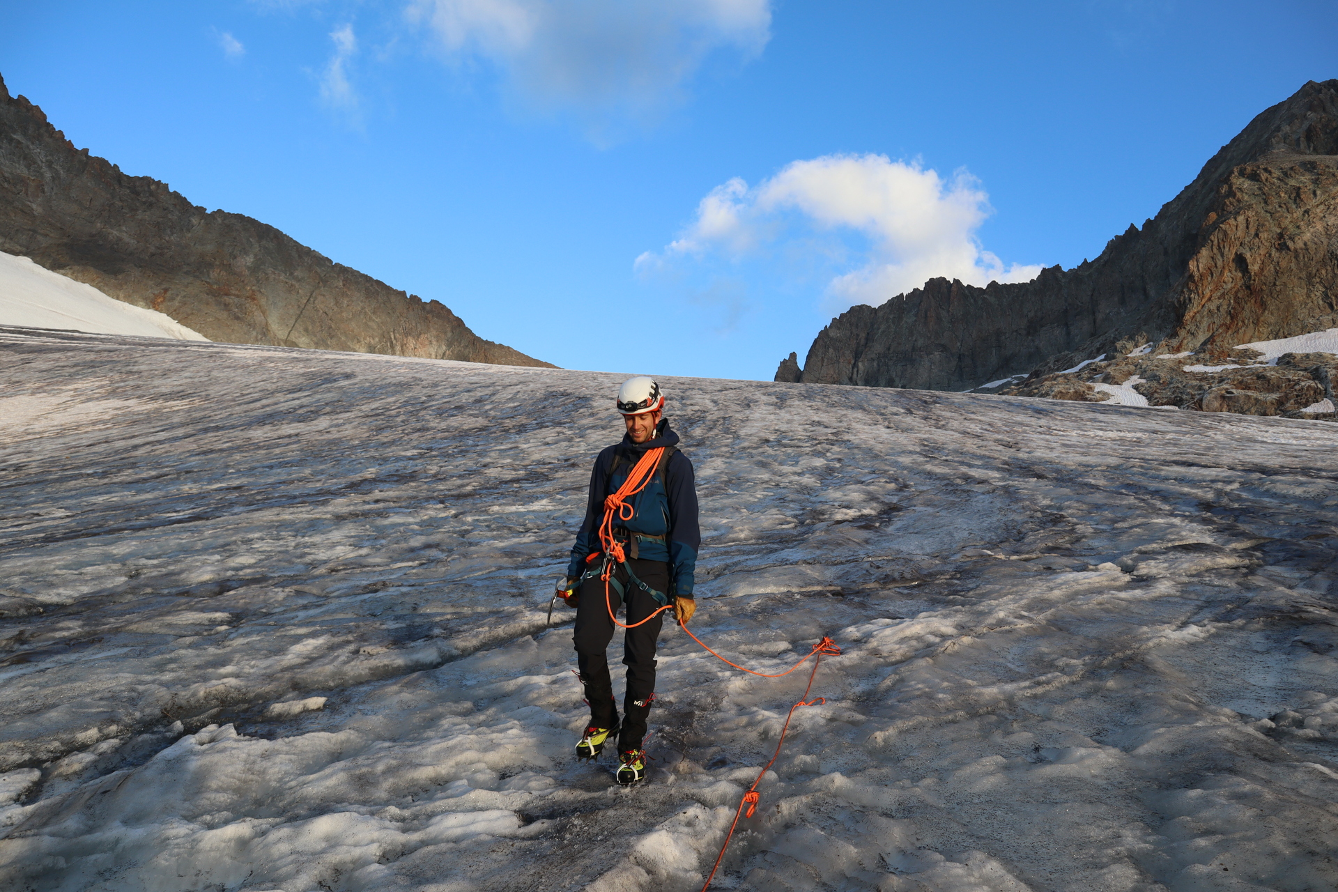 Roped up and wearing crampons on the glacier below the Écrins peaks