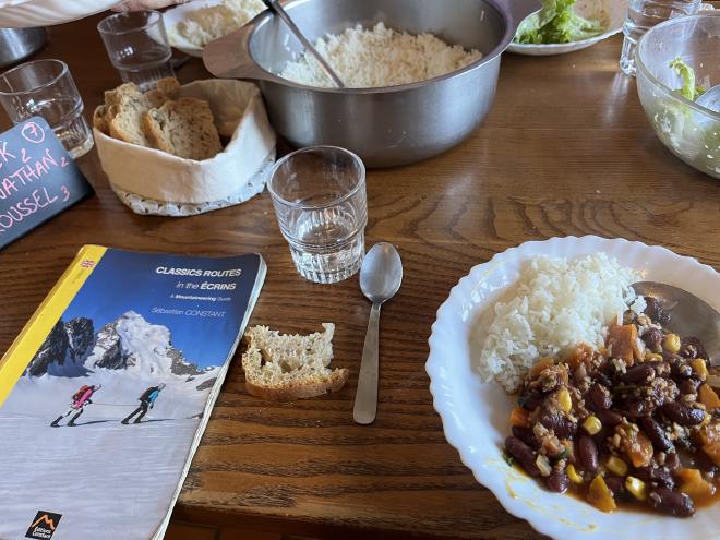 Dinner at the refuge with the Écrins guidebook