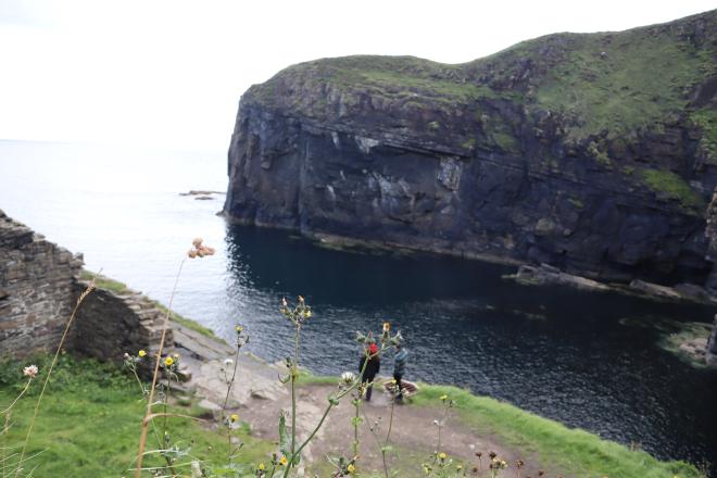 Looking down at the cove and the ruined fish store at the bottom of the Whaligoe Steps