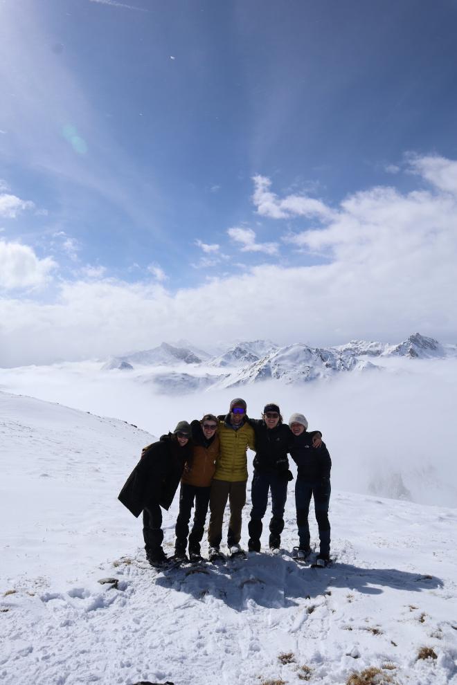 group summit photo on snowy ridge