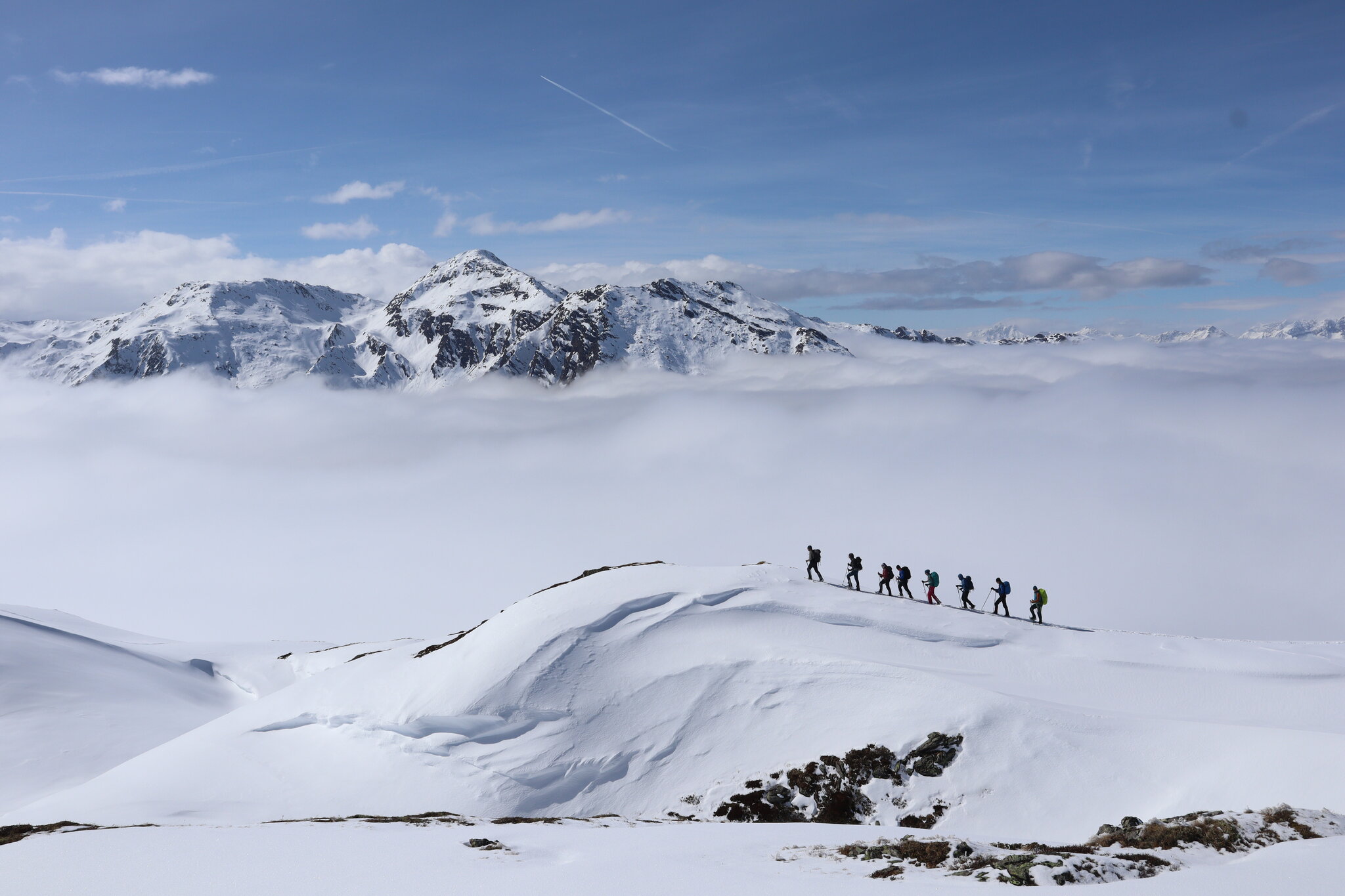 Hikers above sea of clouds