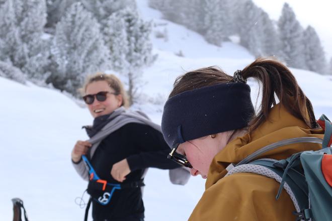 two hikers laughing in snowy forest