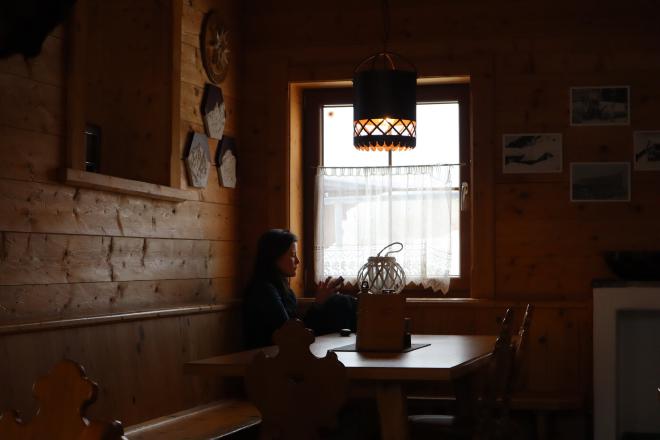 woman resting in mountain hut interior