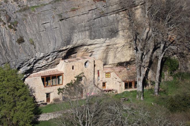 Stone house built into the cliff face